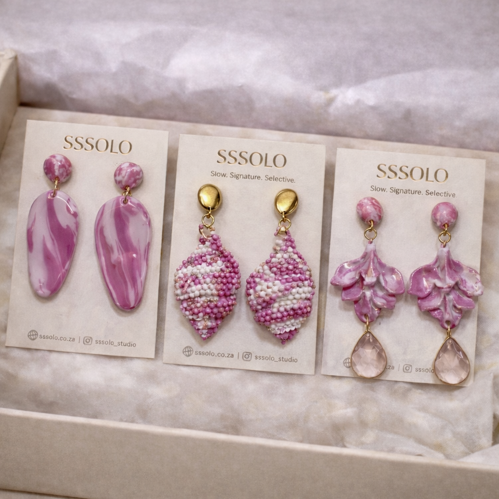 A fuchsia pink and bone coloured earring collection made bespoke for a client.
