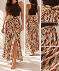 A woman modeling a long wrap-style maxi skirt with a brown and beige abstract pattern, shown in a front view, back view, and two close-up detail panels. She is wearing a dark brown sleeveless top against a bright indoor background with sunlight and shadows.